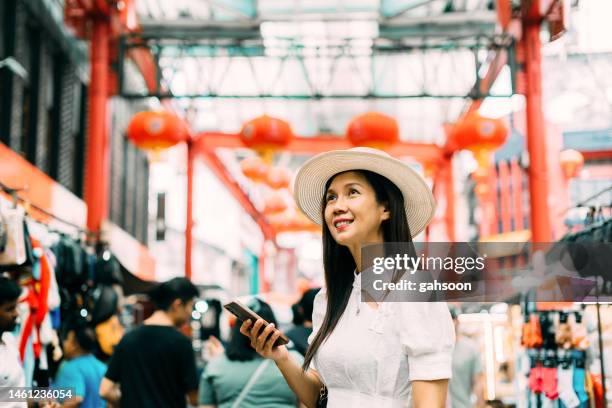 woman with smart phone exploring chinatown of kuala lumpur - asia tradition stock pictures, royalty-free photos & images