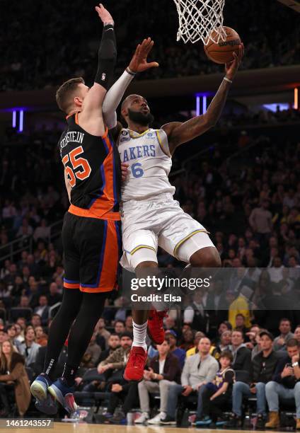 LeBron James of the Los Angeles Lakers heads for the net as Isaiah Hartenstein of the New York Knicks defends in the second half at Madison Square...