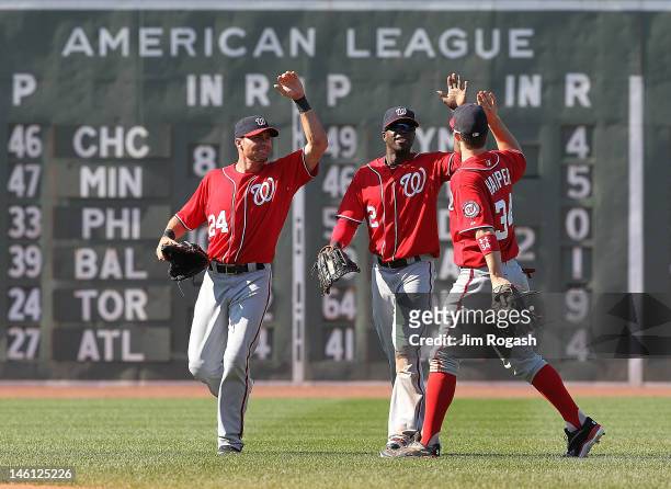 Rick Ankiel, Bryce Harper, and Roger Bernadina of the Washington Nationals celebrate a 4-3 win over the Boston Red Sox during interleague play at...