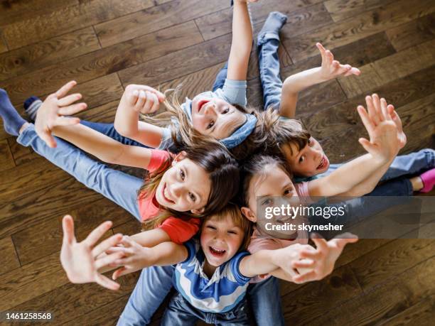 above view of happy kids having fun together on the floor. - children circle floor stock pictures, royalty-free photos & images