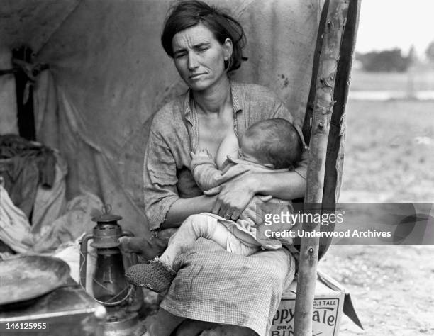 Florence Thompson, age 32, nursing one of her children at a pea pickers camp, Nipomo, California, 1936.