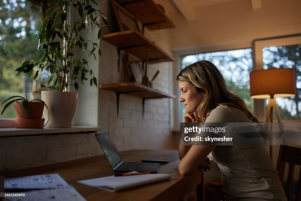 Pensive Woman Reading An Email On A Computer At Home High-Res Stock ...