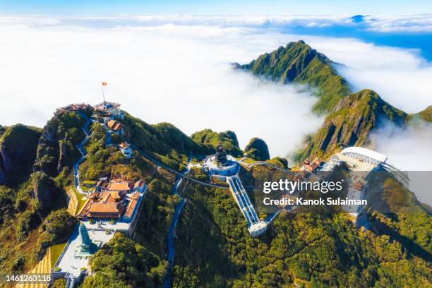 fog covering buddhism temple of fansipan mountain at sa pa in vietnam view from aerial - sa pa stock pictures, royalty-free photos & images