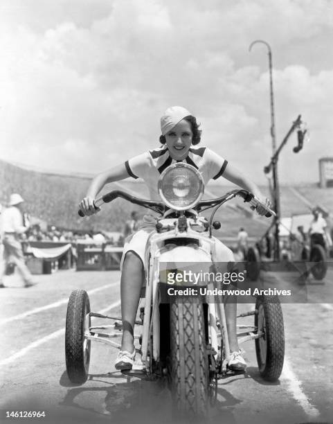 Susan Fleming takes a ride on a three wheeler through the set of 'Million Dollar Legs,' Hollywood, California, 1932.