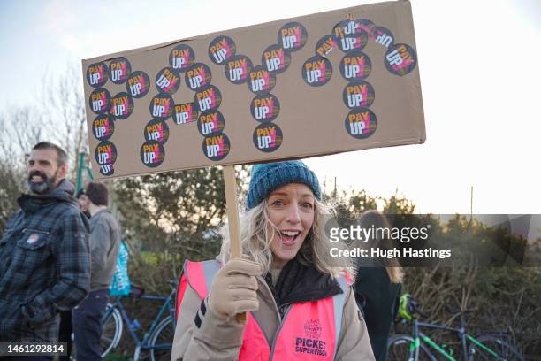 Woman holds a placard as teachers and supporters picket outside Richard Lander co-educational secondary school during a day of national strikes by...