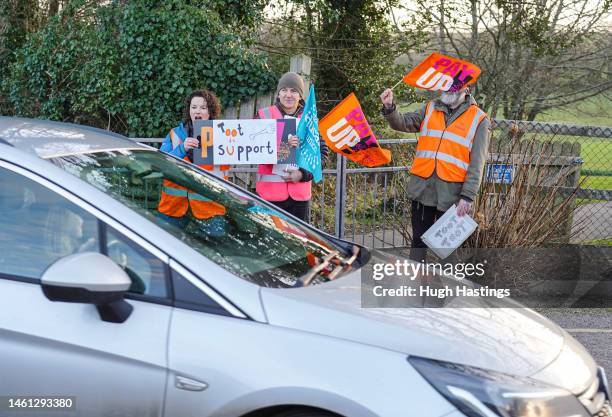 Teachers and supporters wave flags and hold placards as they picket outside Kea Community Primary School during a day of national strikes by many...