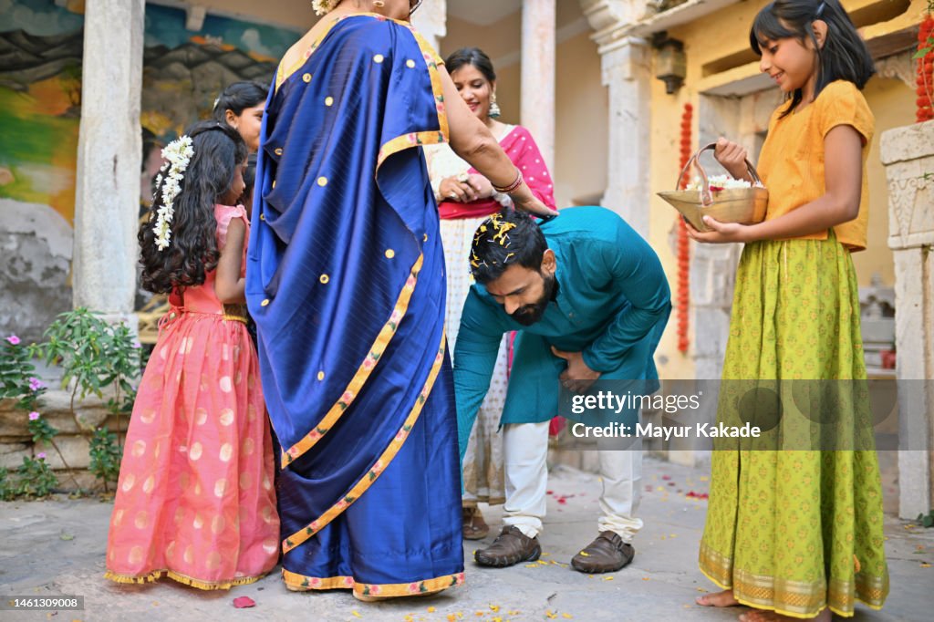 Indian Son touching mother's feet and taking blessings