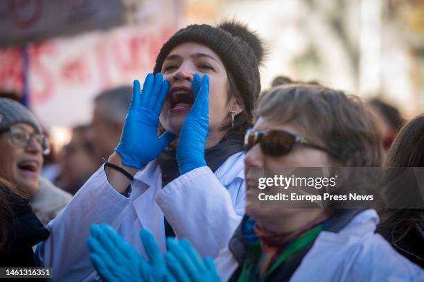 Several people march, some in white coats, during a demonstration called by primary care physicians and pediatricians on February 1 in Madrid, Spain....