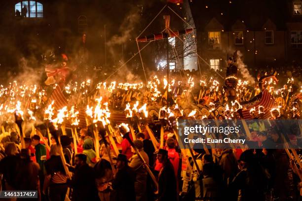 Guizer Jarl Neil Moncrieff stands on the galley surrounded by guizers and his squad, as they light up during the evening procession through Lerwick...