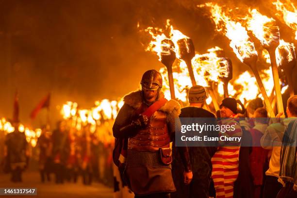 Guizers walking on the torch lit procession before burning during the evening procession of Up Helly Aa 2023 on January 31, 2023 in Lerwick,...