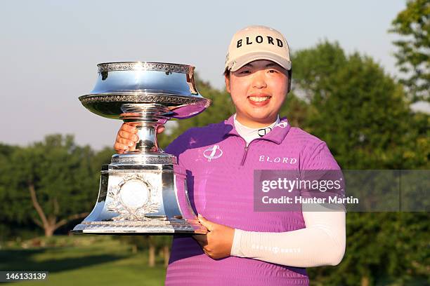 Shanshan Feng of China holds the championship trophy after winning the Wegmans LPGA Championship at Locust Hill Country Club on June 10, 2012 in...