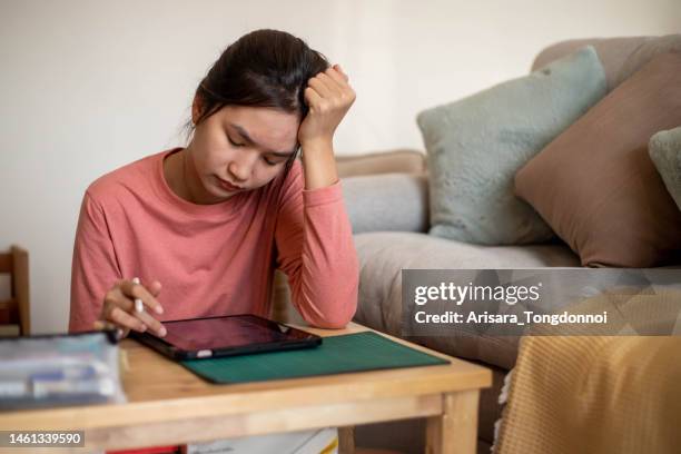 an inventive young woman thinking hard about her design. - hands on a hard body stock pictures, royalty-free photos & images