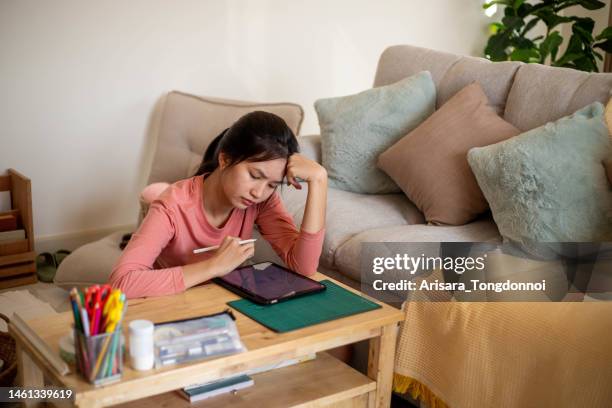 an inventive young woman thinking hard about her design. - hands on a hard body stock pictures, royalty-free photos & images