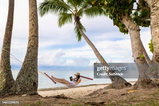 reading in a hammock - fiji people stock pictures, royalty-free photos & images