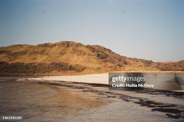 Vintage landscape of beach and hill with blue sky film photography Scotland