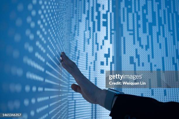 conceptual image using hand to touch screen - interactief stockfoto's en -beelden