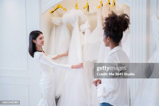 the tailor designs the wedding dress for the bride. - bride dress stock pictures, royalty-free photos & images