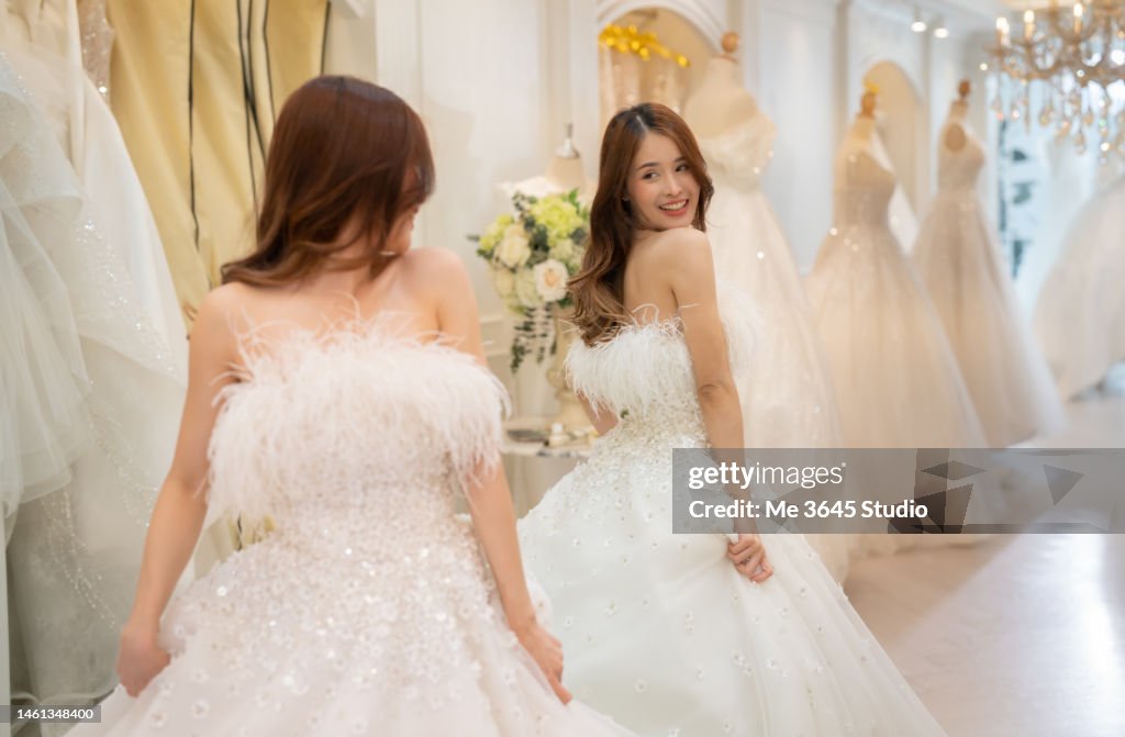 The tailor designs the wedding dress for the bride.