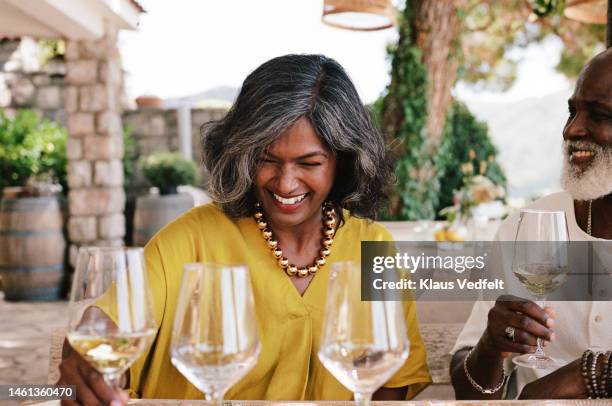 mature woman enjoying wine tasting with friend - friendship necklace stock pictures, royalty-free photos & images