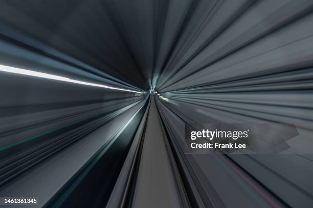 driver pov over single metro tunnel as seen from a driverless metro train - road richtung power station bei nacht stock-fotos und bilder