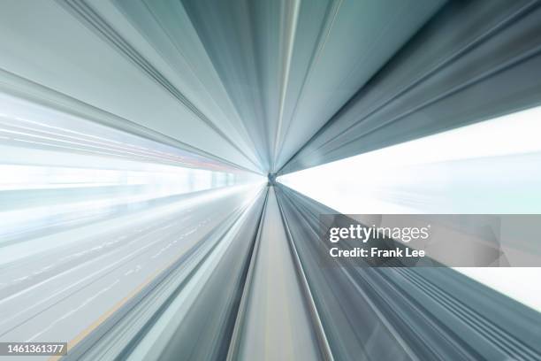 driver pov over single metro tunnel as seen from a driverless metro train - road richtung power station bei nacht stock-fotos und bilder