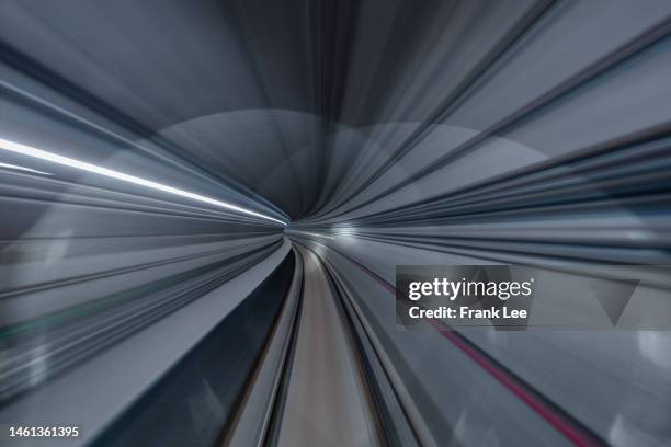 driver pov over single metro tunnel as seen from a driverless metro train - road richtung power station bei nacht stock-fotos und bilder