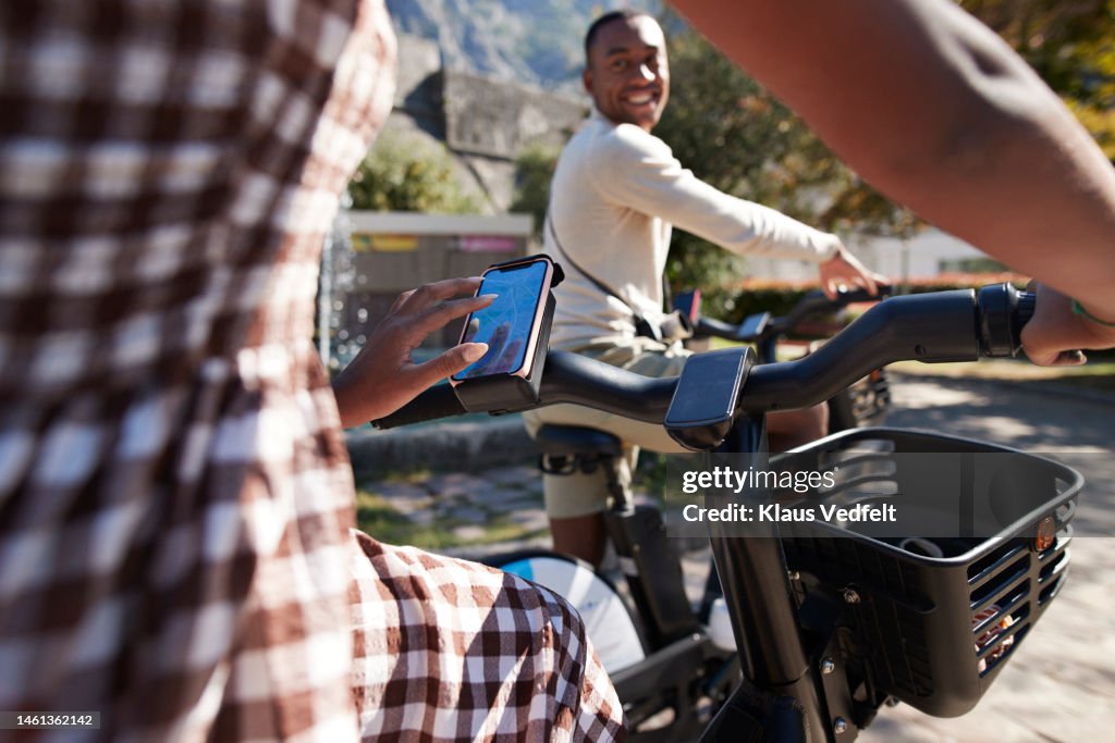 Woman using smart phone on electric bicycle
