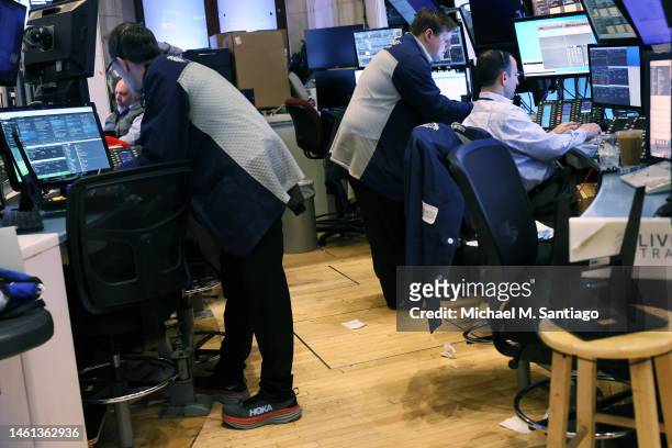 Traders work on the floor of the New York Stock Exchange during morning trading on February 01, 2023 in New York City. Stocks opened low this morning...