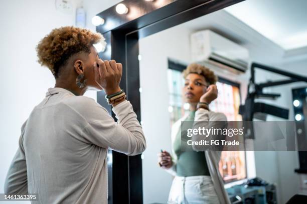 mid adult woman doing make-up at a beauty salon - mascara stockfoto's en -beelden