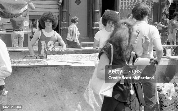 View of two vendors grilling at their food stall on 9th Avenue in Hell's Kitchen during the International Food Festival, New York, New York, May 20,...