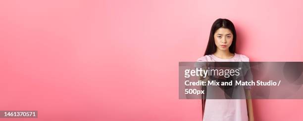 she says no serious asian girl shaking finger in stop gesture - shaking finger stock pictures, royalty-free photos & images