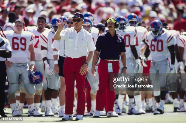 Billy Brewer , Head Coach for the University of Mississippi Ole Miss Rebels gives hand sign instructions to his players from the sideline during the...