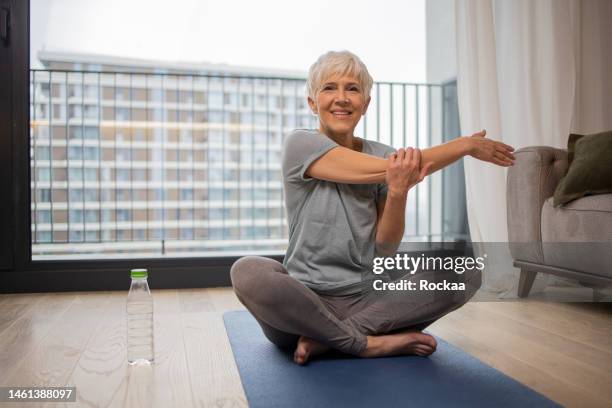 woman training at home - senior yoga lady stock pictures, royalty-free photos & images