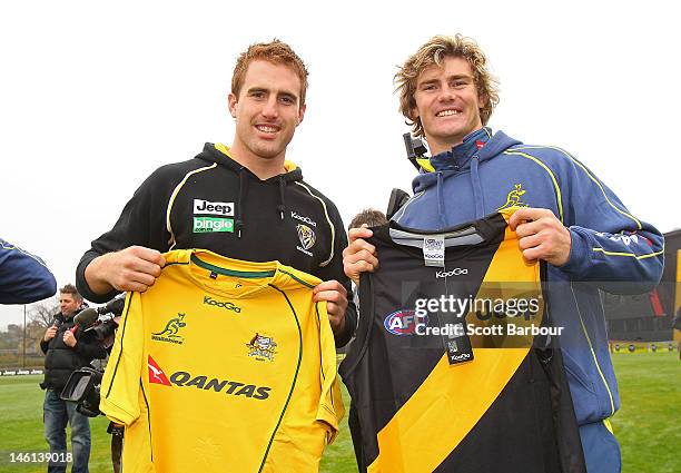 Daniel Jackson of the Richmond Tigers AFL team and Berrick Barnes of the Wallabies exchange jumpers during an Australian Wallabies fan day at Punt...