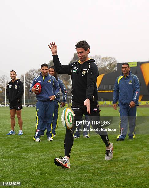 Chris Newman of the Richmond Tigers AFL team kicks a rugby ball during an Australian Wallabies fan day at Punt Road Oval on June 11, 2012 in...