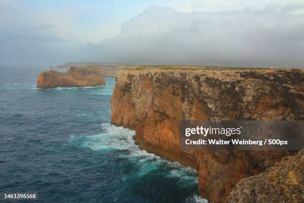 scenic view of sea by cliff against sky,sagres,portugal - sagres ストックフォトと画像