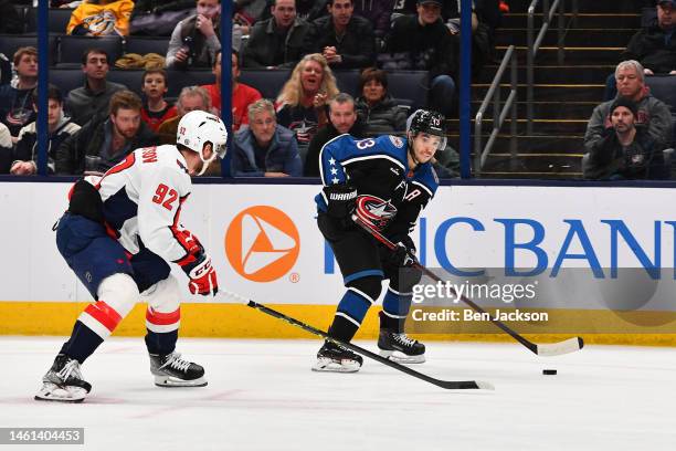 Johnny Gaudreau of the Columbus Blue Jackets skates with the puck as Evgeny Kuznetsov of the Washington Capitals defends during the third period of a...