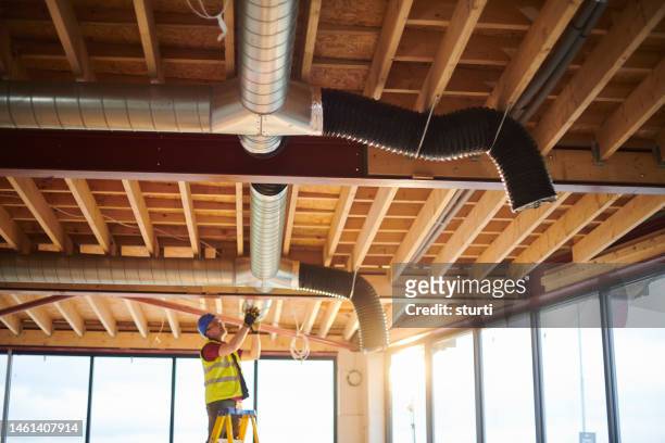 heating duct install - laying stock pictures, royalty-free photos & images