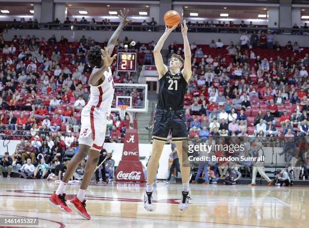 Liam Robbins of the Vanderbilt Commodores shoots a three during the second half over Noah Gurley of the Alabama Crimson Tide at Coleman Coliseum on...