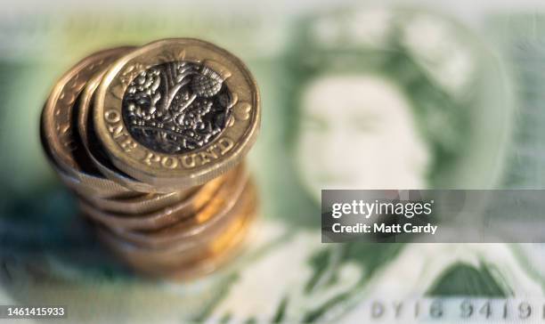 In this photo illustration, British GDP £1 coins are pictured with a old one pound note on October 08, 2022 in Bath, England. The value of the UK...