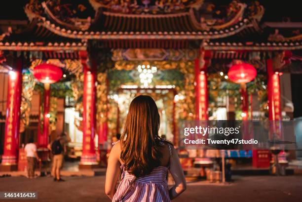 young asian woman standing at chinese temple while traveling in bangkok chinatown - temple body part stock pictures, royalty-free photos & images