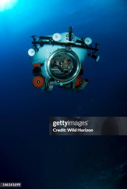 Three man mini-sub in mid-water over coral reef, Sea Aquarium Reef, Curacao, Netherlands Antilles, Model and Property Released,