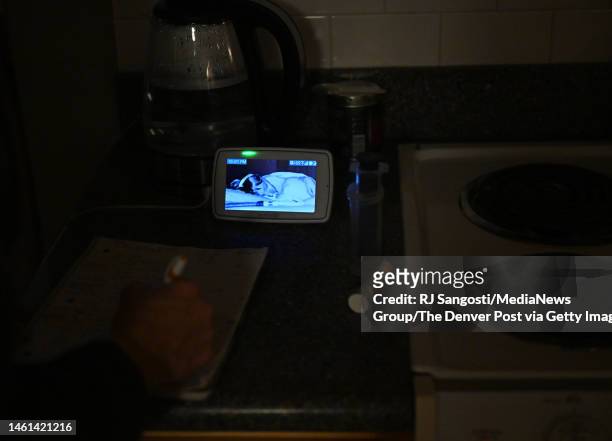 Amy Wiedeman uses a baby monitor to keep an eye on her 12-year-old son Luke Schiller as he sleeps on January 31, 2023 in Centennial, Colorado....