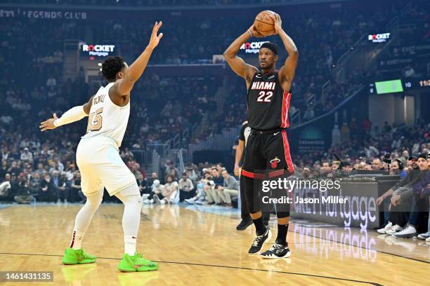 Jimmy Butler of the Miami Heat looks for a pass as Donovan Mitchell of the Cleveland Cavaliers guards during the first half at Rocket Mortgage...