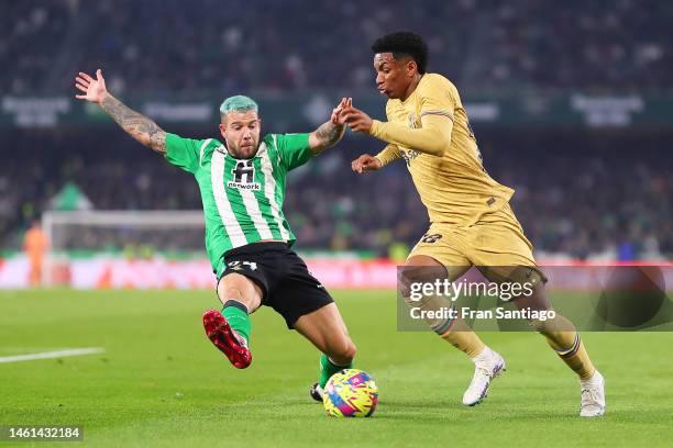 Alejandro Balde of FC Barcelona is challenged by Aitor Ruibal of Real Betis during the LaLiga Santander match between Real Betis and FC Barcelona at...