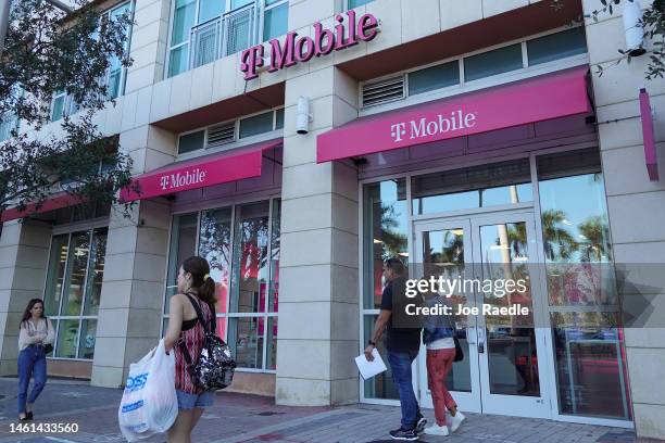 Pedestrians walk past a T-Mobile store on February 01, 2023 in Miami, Florida. The company reported that in the fourth quarter, profits more than...