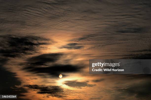 Cirrocumulus and altostratus clouds with disk of sun showing through, Near Natural Bridge State Park, Kentucky, USA,