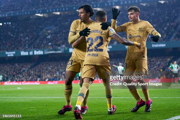 Raphinha of FC Barcelona celebrates with team mates after scoring his team's first goal during the LaLiga Santander match between Real Betis and FC...