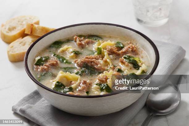 creamy cheese tortellini with spicy italian sausage soup - soup bowl stock pictures, royalty-free photos & images