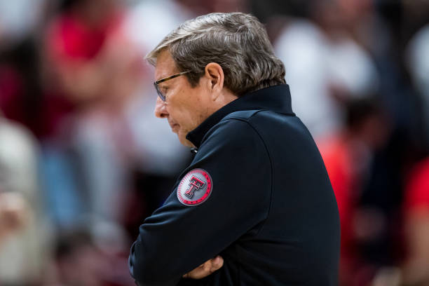Head coach Mark Adams of the Texas Tech Red Raiders walks across the court during a timeout during overtime of the college basketball game against...